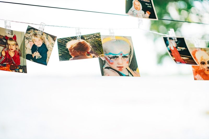 Childhood pictures of the bride and groom were strung up around the tent for the guests to enjoy.