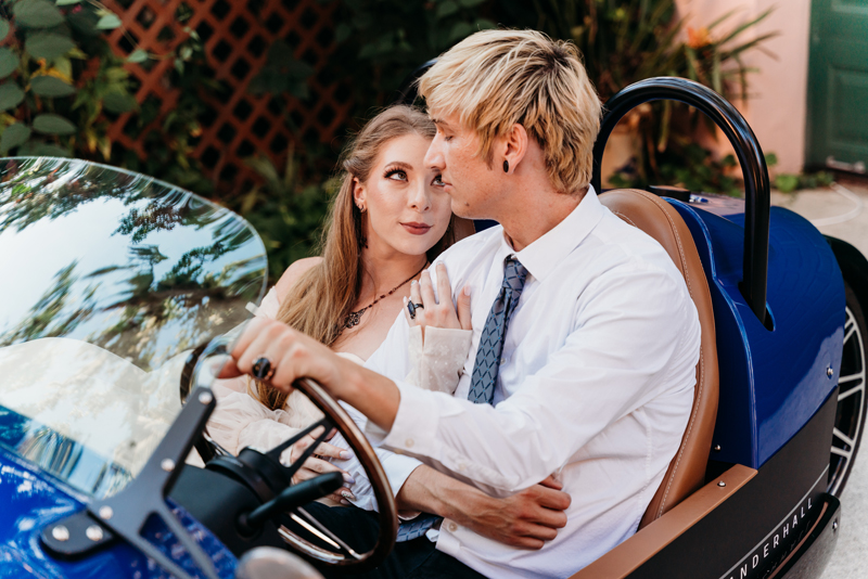 Elopement Photographer, husband and wife sit in a go-kart as he drives