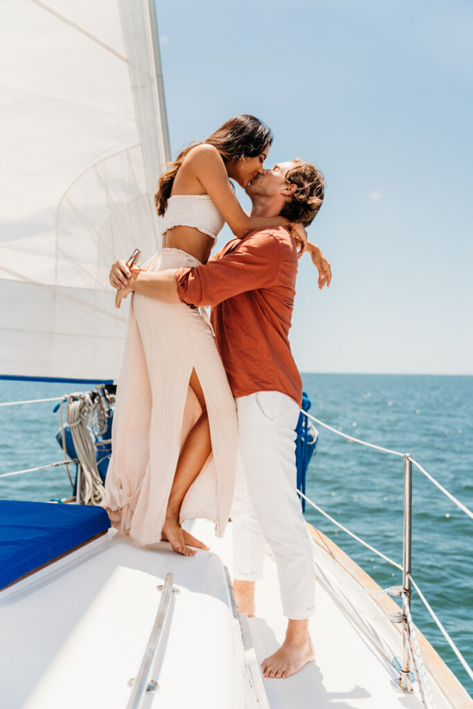 Elopement Photographer, man and woman kiss on a sailboat out to sea
