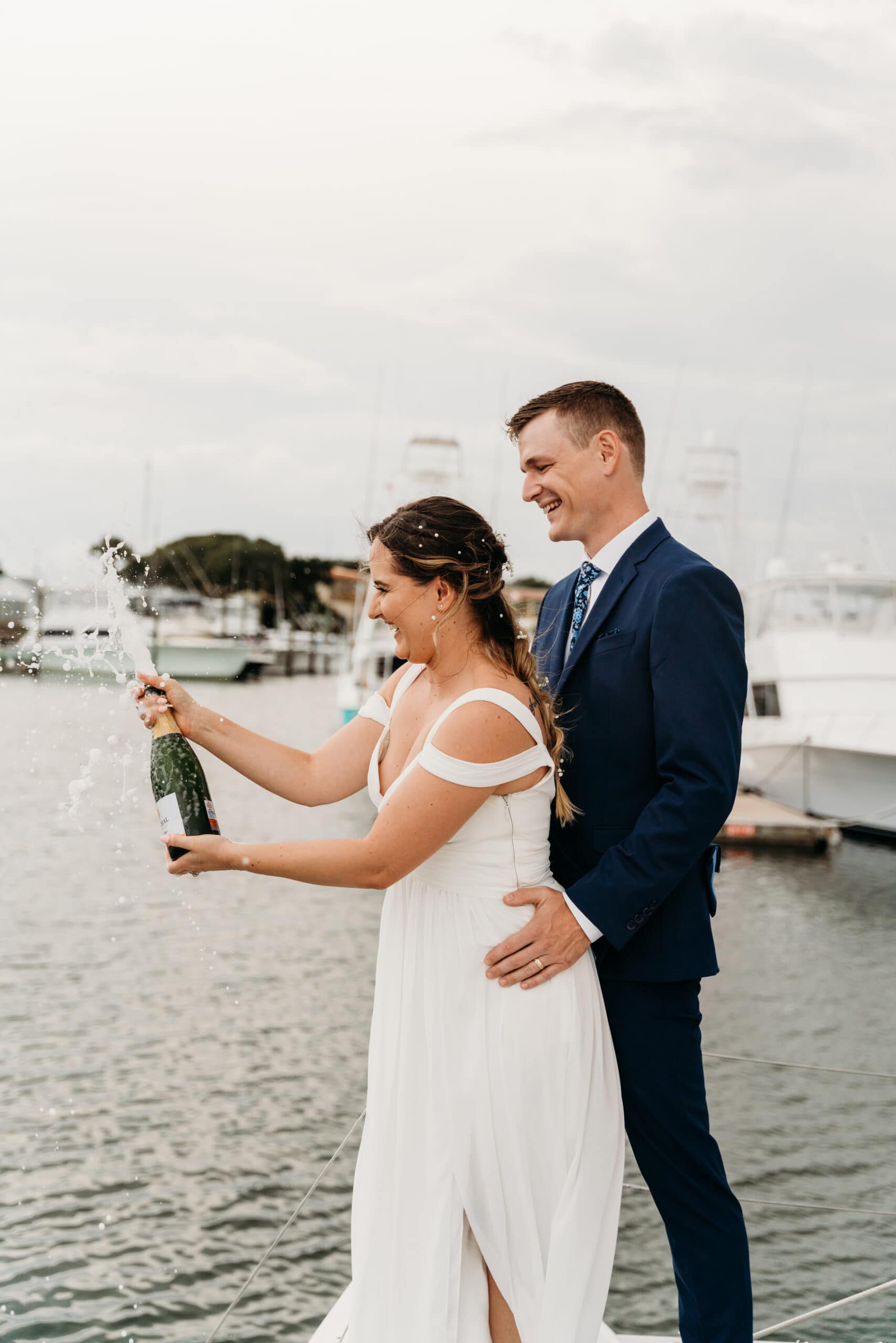 champagne pop on boat elopement