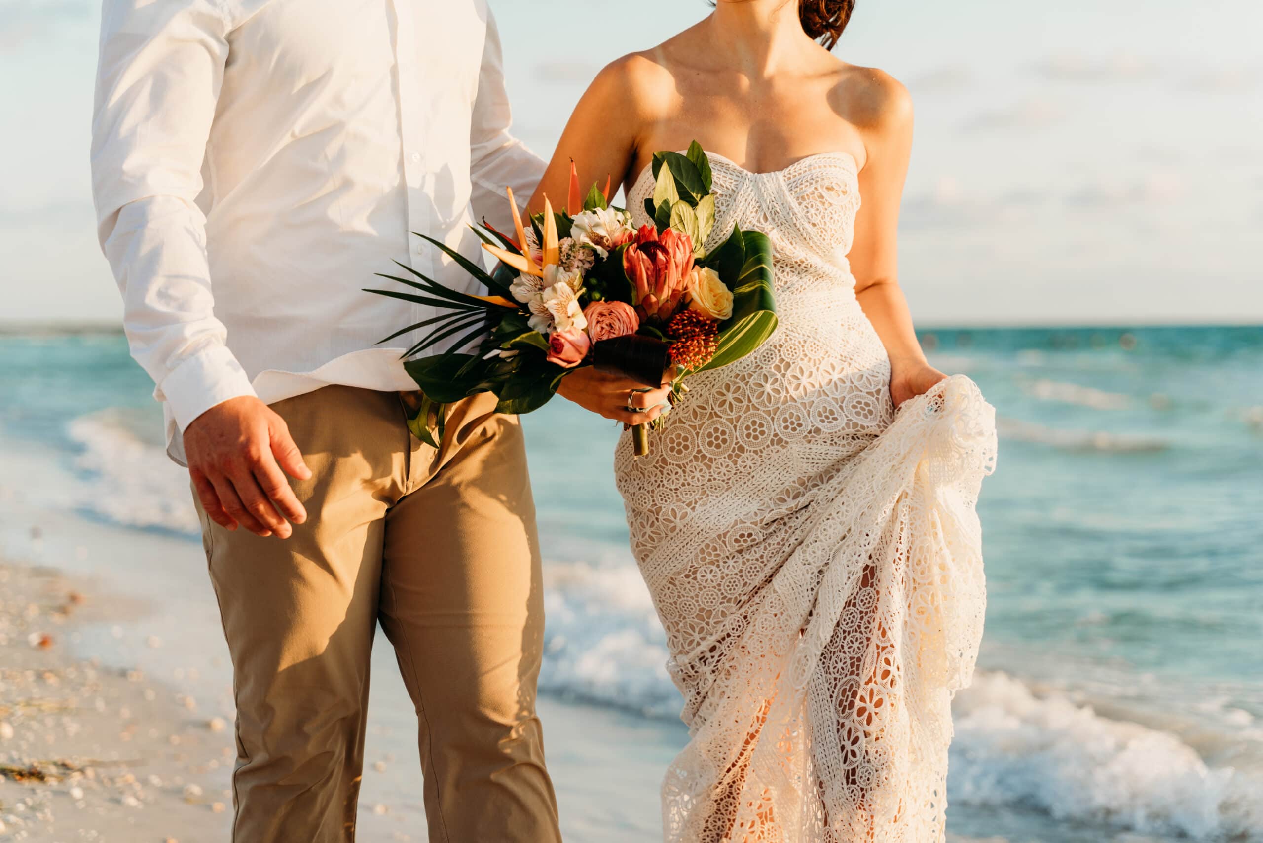 bride and groom walk together on clearwater beach after elopement ceremony
