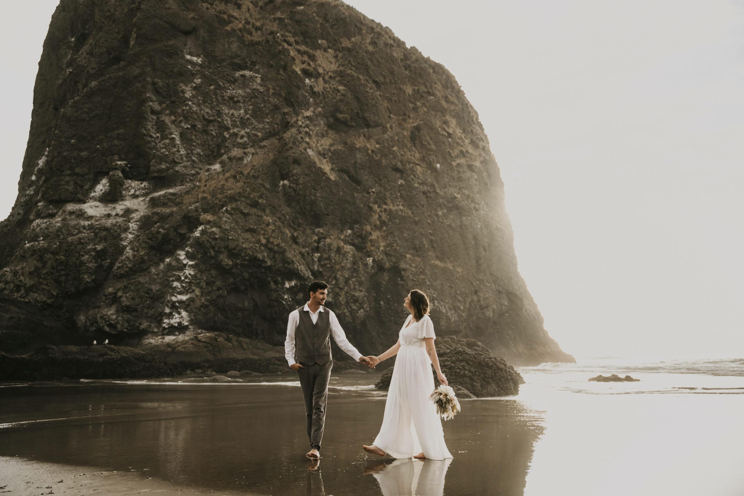 Cannon beach elopement with bride and groom at sunset in Oregon
