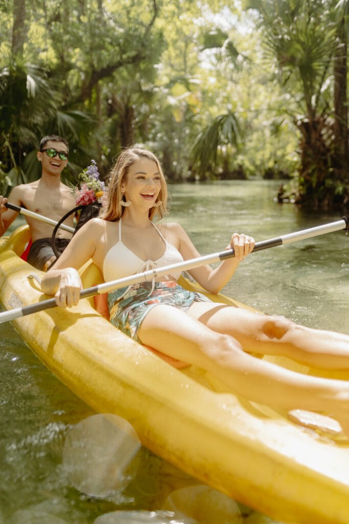 bride and groom kayak in the florida springs after elopement
