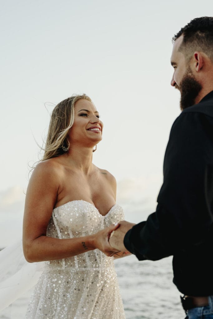 bride and groom exchange vows at sunrise during their elopement