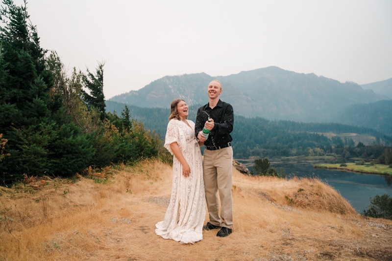 Couple sprays champagne after saying vows at their Oregon elopement